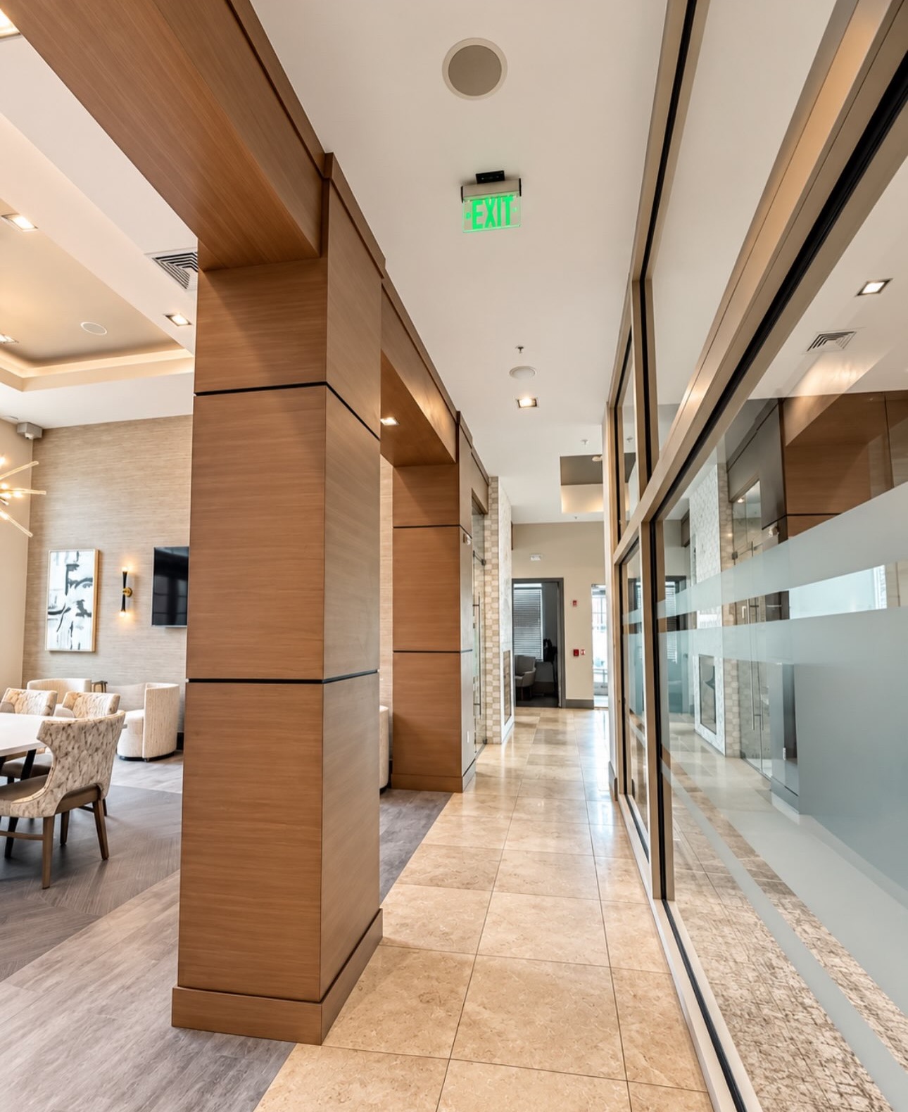 Interior corridor with wood columns and glass partitions
