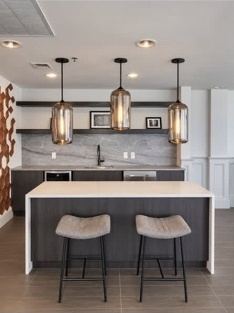 Contemporary kitchen with white island and pendant lighting